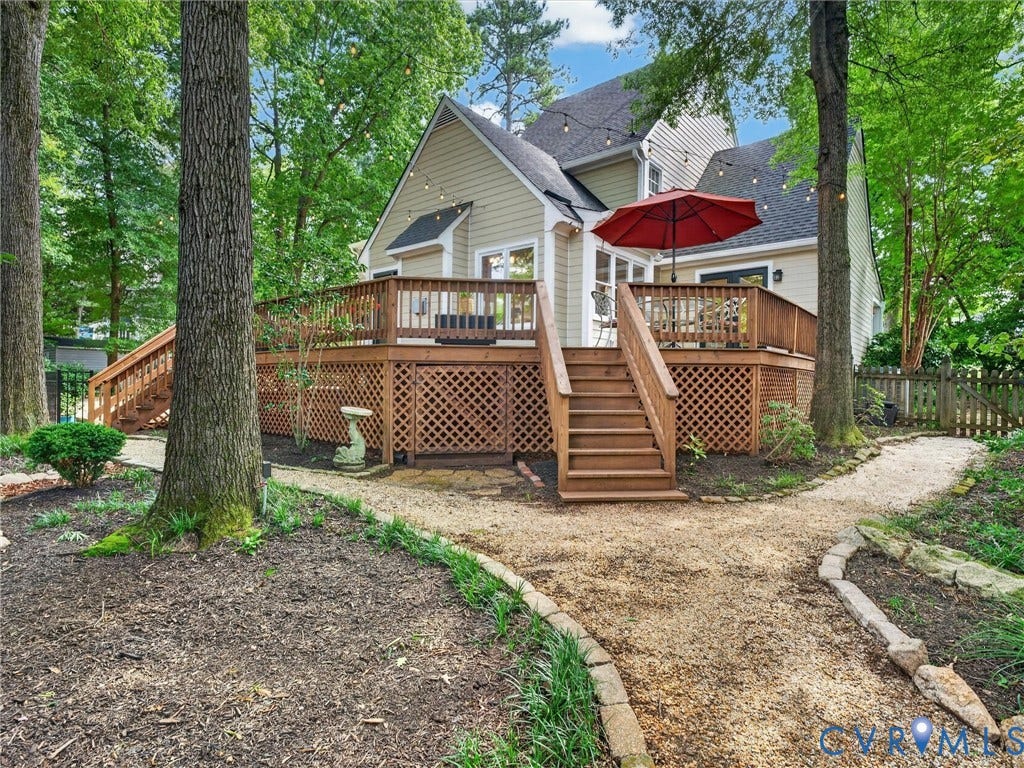 Multi-level wooden deck featuring lattice skirting, steps, and a wooden railing