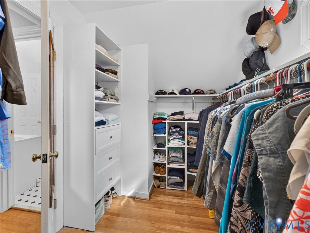 Custom closet system featuring built-in shelving, drawers, and hanging rods