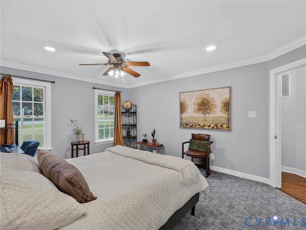 Recessed lighting, ceiling fan, crown molding, double-pane windows, and gray patterned carpeting