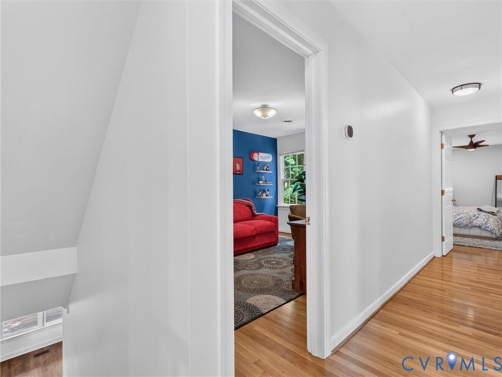Hardwood flooring, recessed lighting, and a ceiling fan in an adjacent room