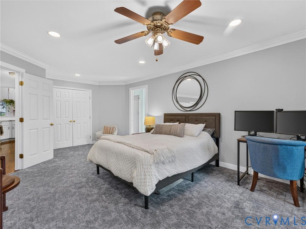 Recessed lighting, ceiling fan, crown molding, double bifold doors, and patterned carpet flooring