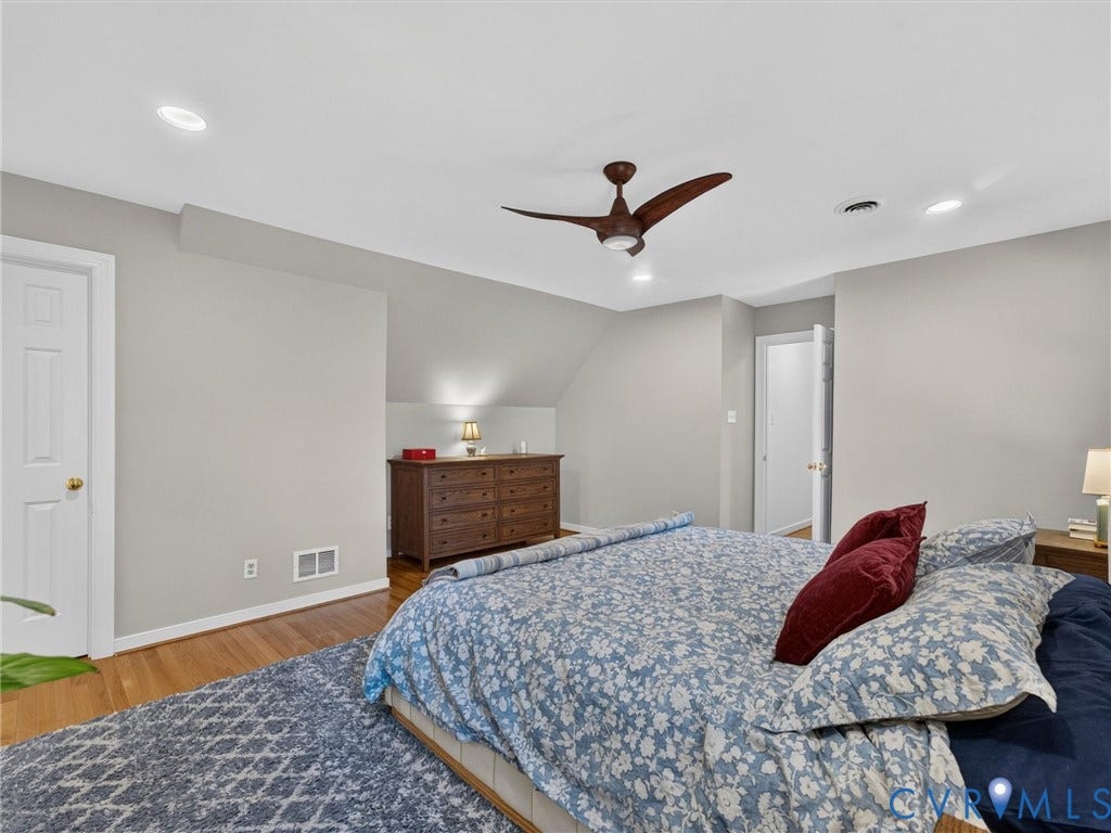 Recessed ceiling lighting, wood-finish flooring, and a ceiling fan with integrated lighting
