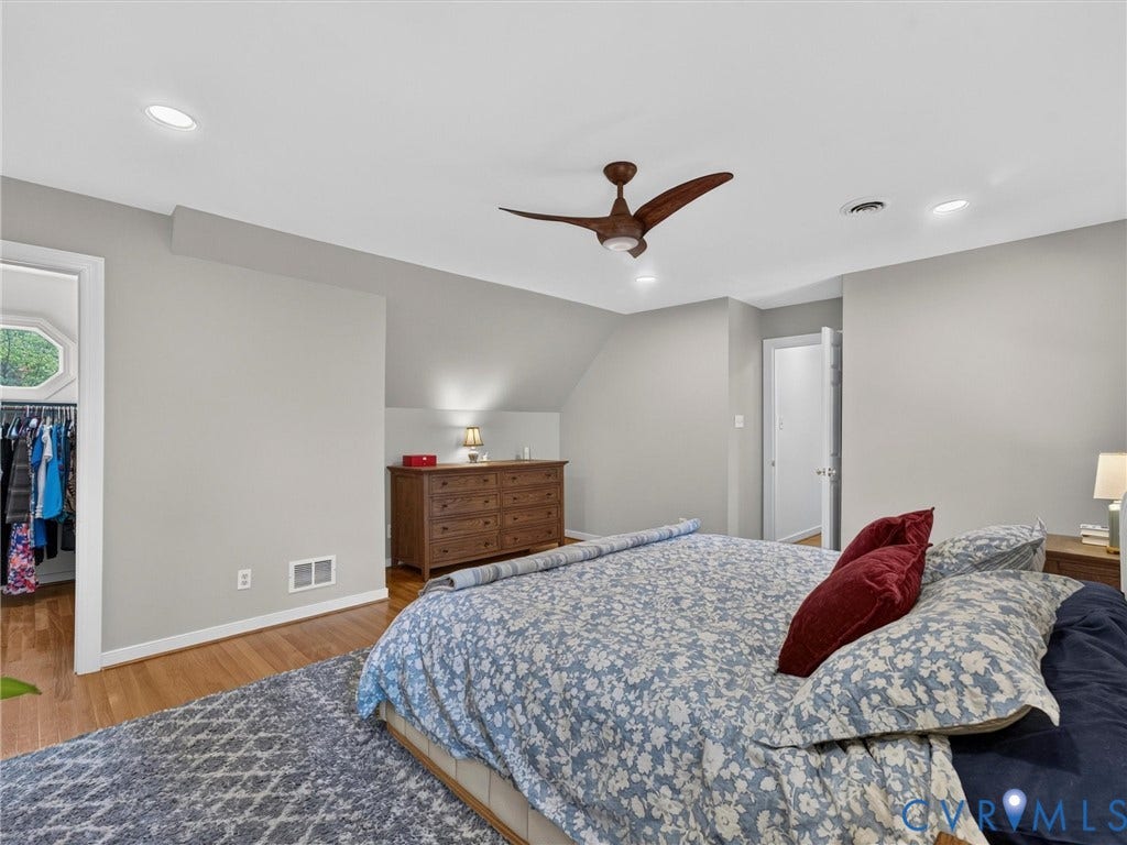 Recessed ceiling lighting, wood-finish flooring, ceiling fan, and sloped ceiling accents