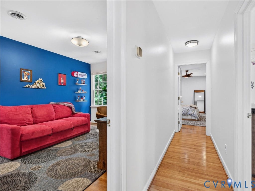Hallway with wood-finish flooring and flush-mount lighting