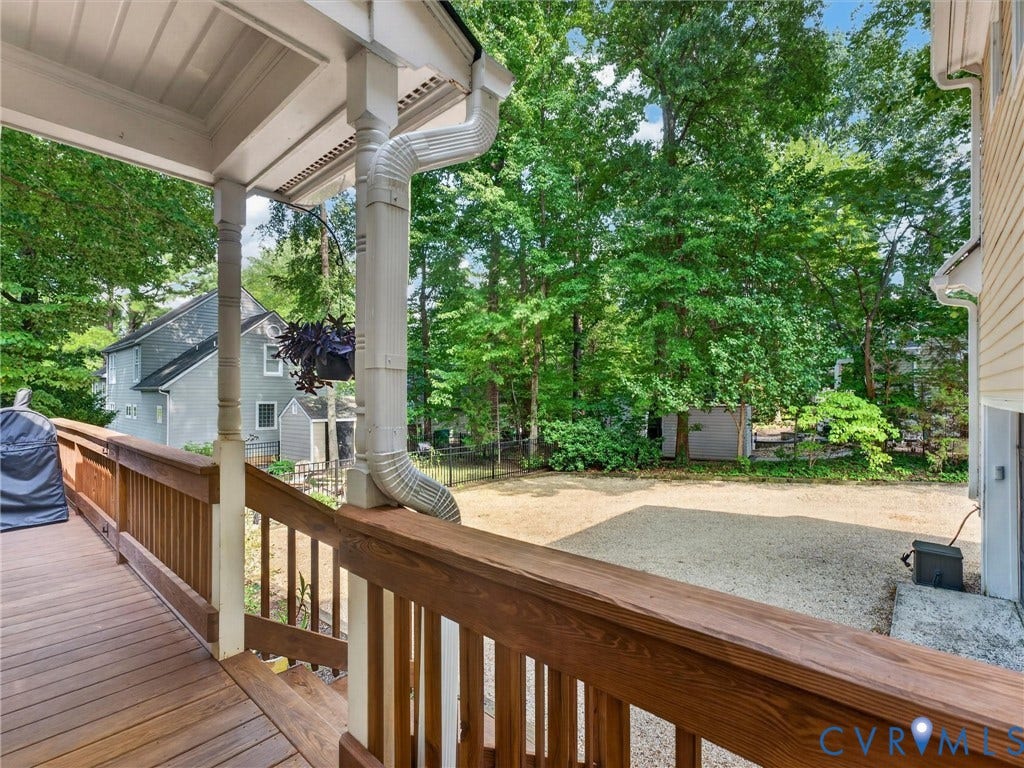 Expansive wooden deck with coordinating railings, offering a private outdoor area