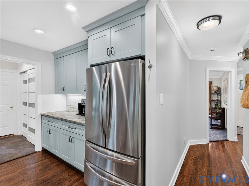 Contemporary kitchen cabinetry with integrated stainless steel refrigerator