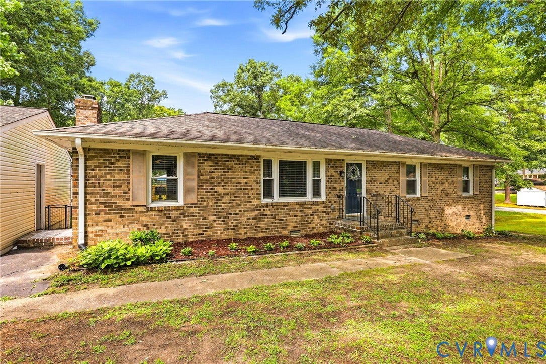 3300 Woodsong Drive, Midlothian, VA 23112 Brick ranch-style exterior with a dark blue front door