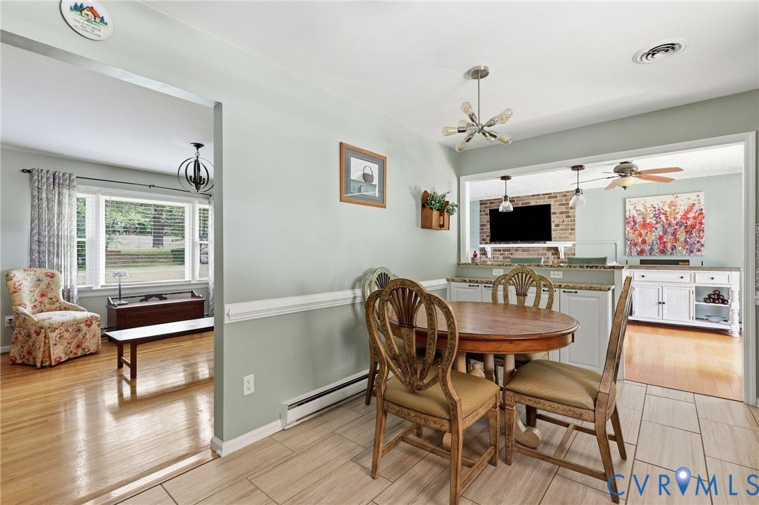 3300 Woodsong Drive, Midlothian, VA 23112 Open concept living area with light wood-finish flooring and large window