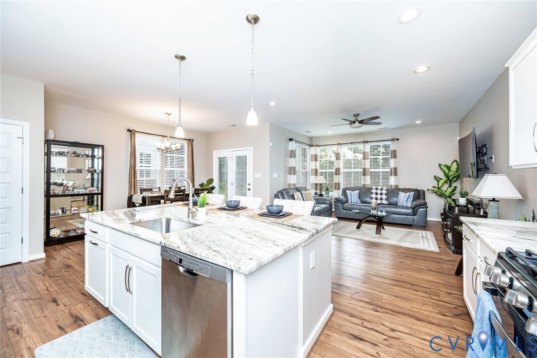 7205 Desert Candle Drive, Moseley, VA 23120 Kitchen island with integrated stainless steel sink and granite countertops