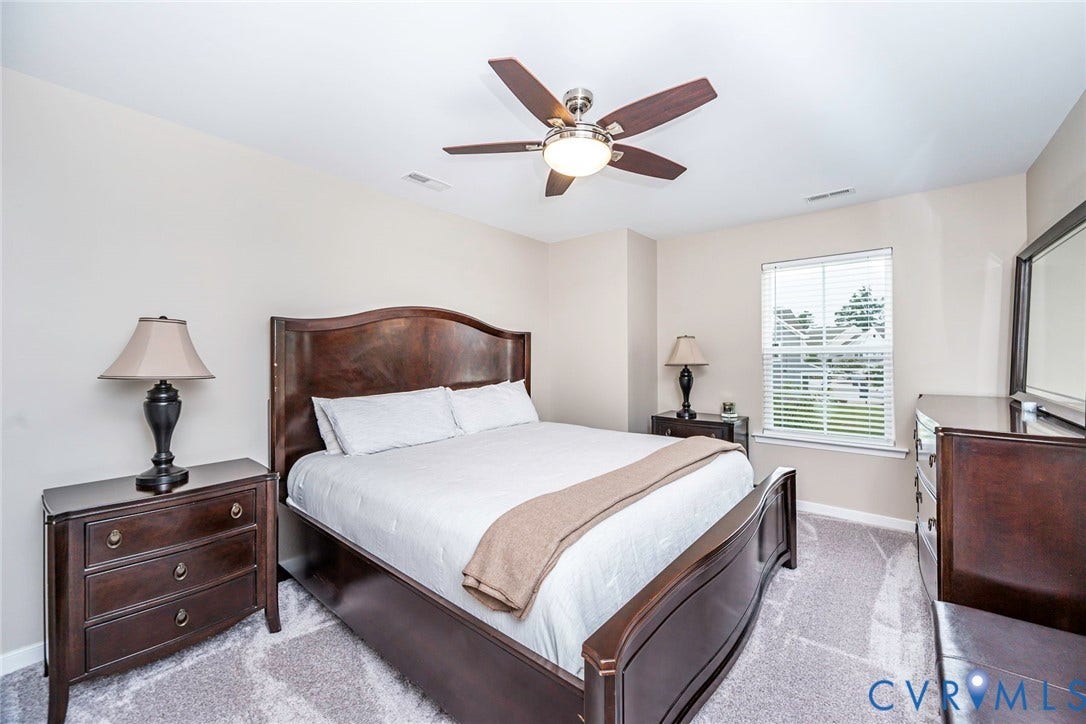 7205 Desert Candle Drive, Moseley, VA 23120 Guest room featuring neutral wall tones, a ceiling fan with integrated lighting, and carpeted flooring