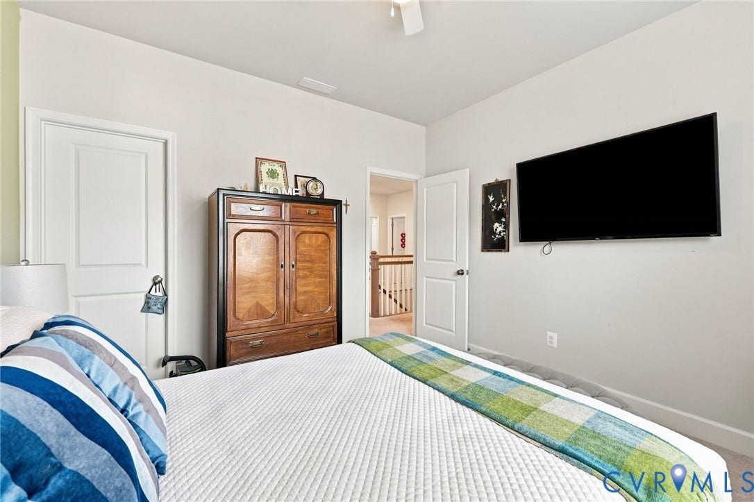 Bedroom featuring light-toned walls, white trim, and white paneled doors