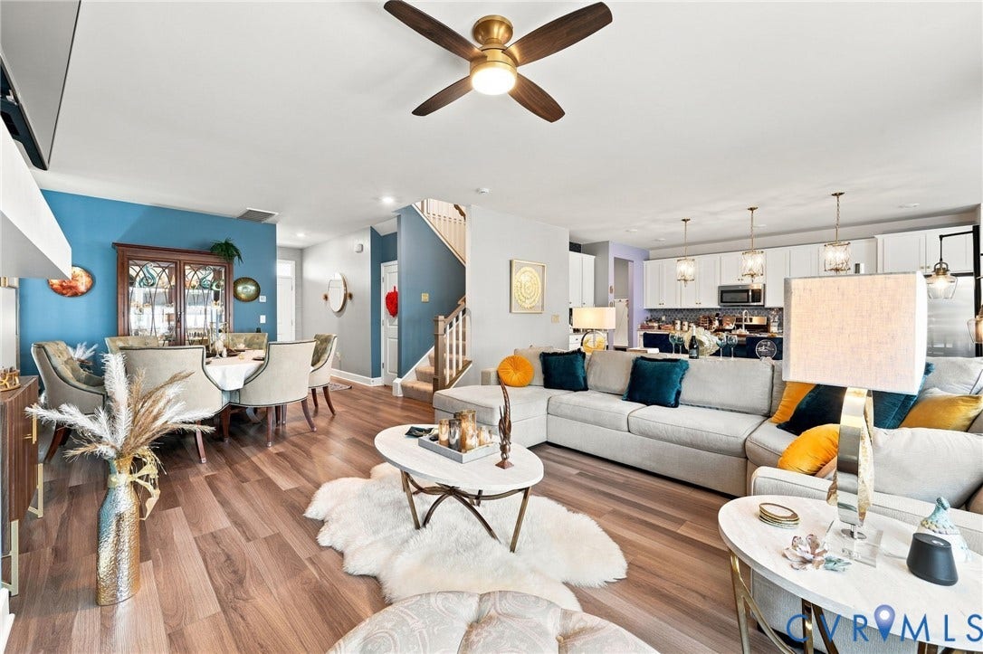 Open-concept main living area featuring wood-finish flooring, a contemporary ceiling fan, and recessed lighting