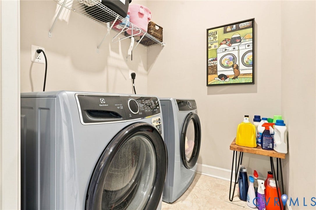 Dedicated laundry area featuring a front-load washer and dryer set