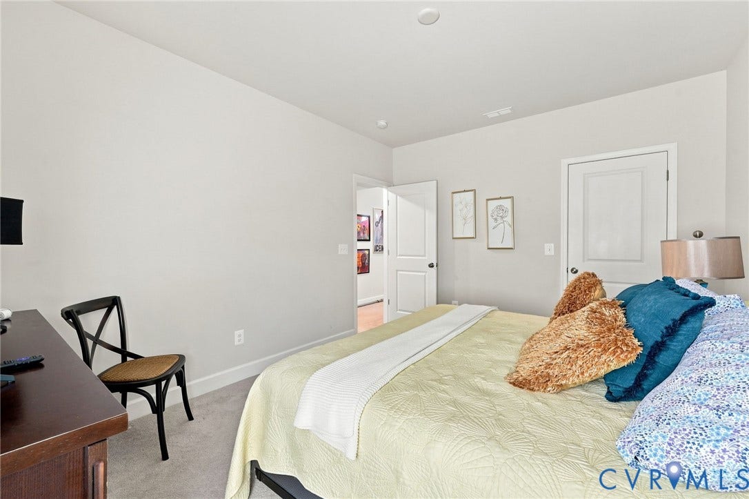 Light gray walls complement the neutral carpet flooring