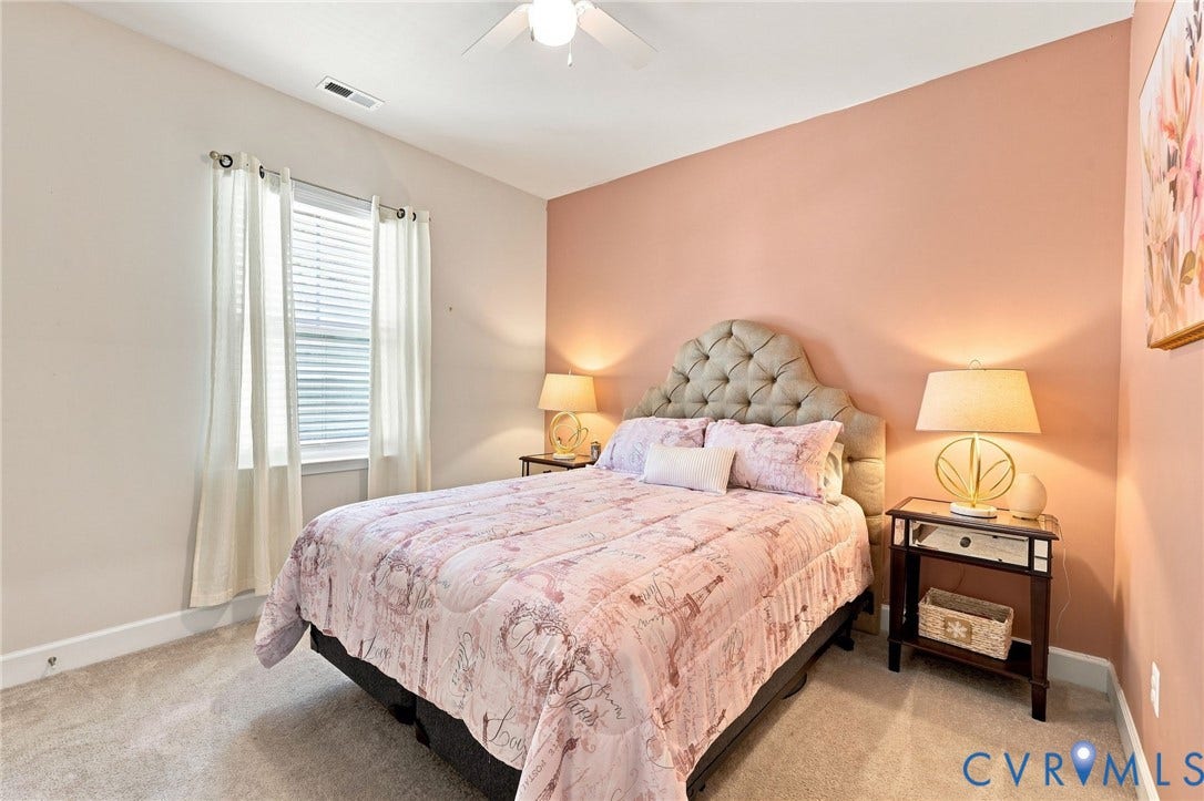 Bedroom featuring a neutral carpet, a window with blinds, and a ceiling fan