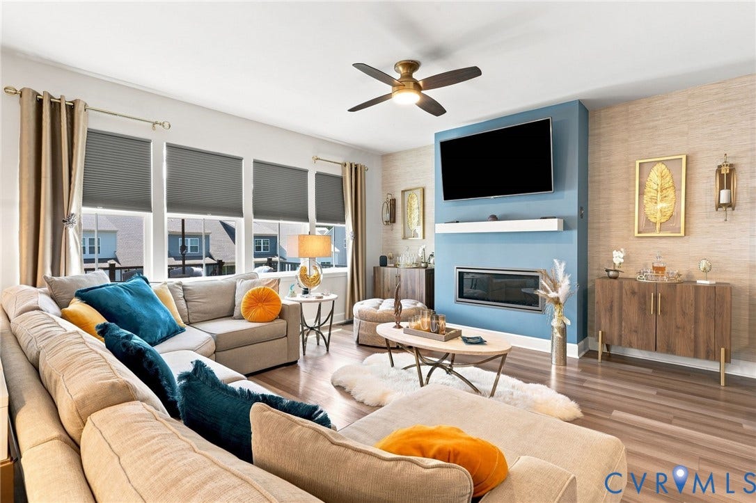 Sophisticated living room showcasing a custom blue built-in entertainment center with fireplace, wall-mounted flat-screen television, and integrated shelving