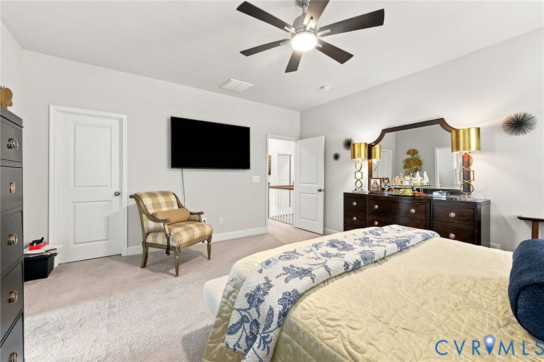 Carpeted bedroom featuring light gray wall paint and white trim