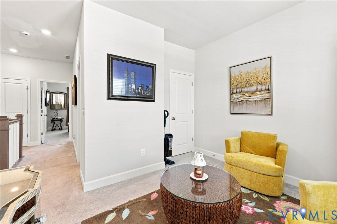 Upper-level landing featuring light-colored walls, recessed lighting, and white baseboards