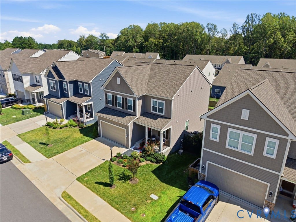 Aerial perspective showcasing residential properties with varied siding materials