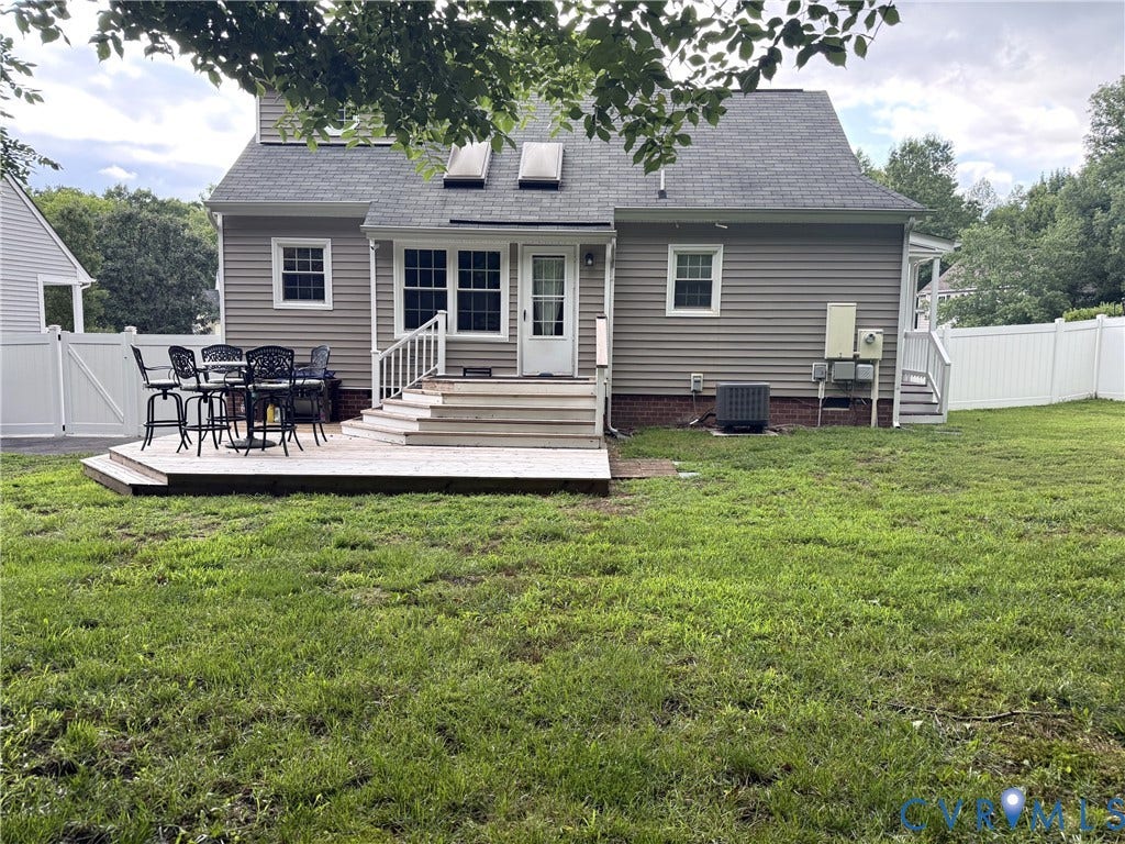 Rear exterior featuring a multi-level wood deck with a privacy fence