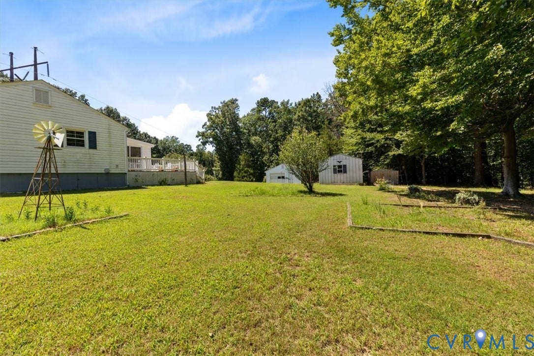 2311 Georges Road, Powhatan, VA 23139 Expansive green lawn with mature trees and a rear deck