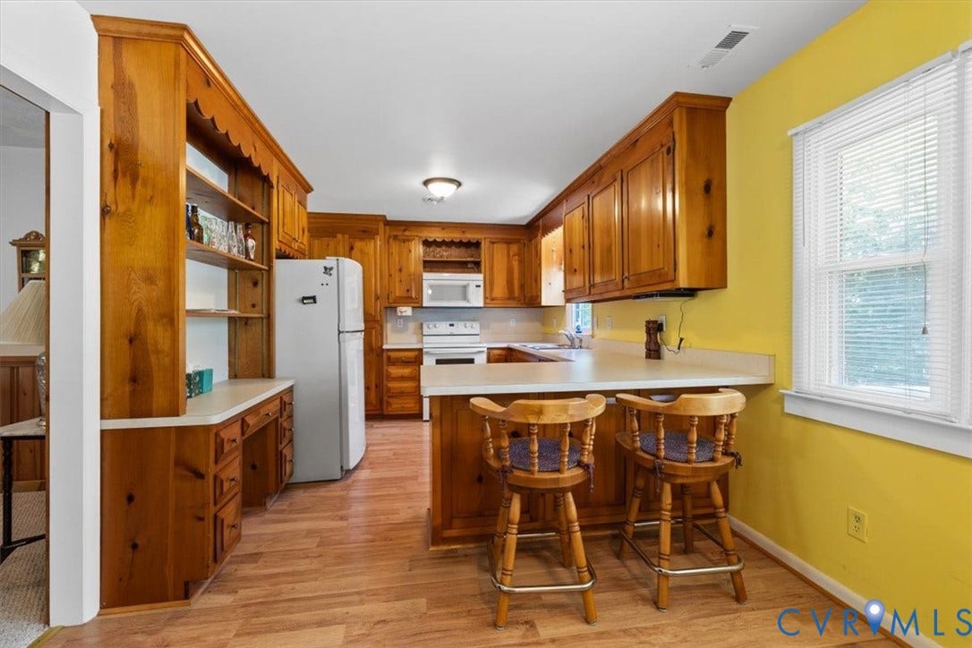 2311 Georges Road, Powhatan, VA 23139 Kitchen featuring wood-finish cabinetry, light-toned countertops, and wood-finish flooring
