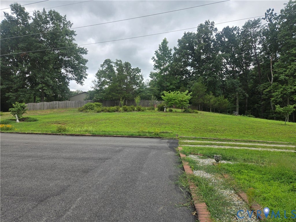 2311 Georges Road, Powhatan, VA 23139 Grassed lot with mature trees, established street access, and a partial wood fence boundary