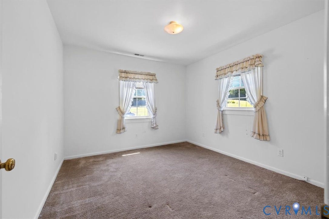 2311 Georges Road, Powhatan, VA 23139 Carpeted room featuring two windows and a flush-mount ceiling light fixture