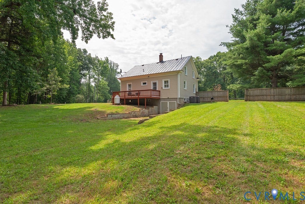 4808 River Road W Road, Goochland, VA 23063 Expansive green lawn with mature trees and a wooden privacy fence