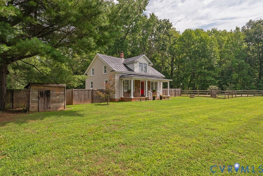 4808 River Road W Road, Goochland, VA 23063 Expansive green lawn surrounding a light-colored home with a covered front porch and red entry door