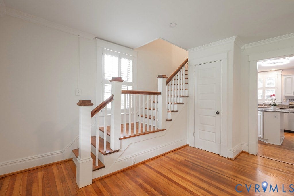 4808 River Road W Road, Goochland, VA 23063 Hardwood flooring throughout featuring a staircase with white balusters and wood-finish handrails