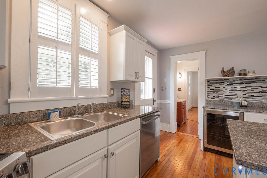 4808 River Road W Road, Goochland, VA 23063 Kitchen featuring granite-style countertops, stainless steel double basin sink, white cabinetry, and wood-finish flooring