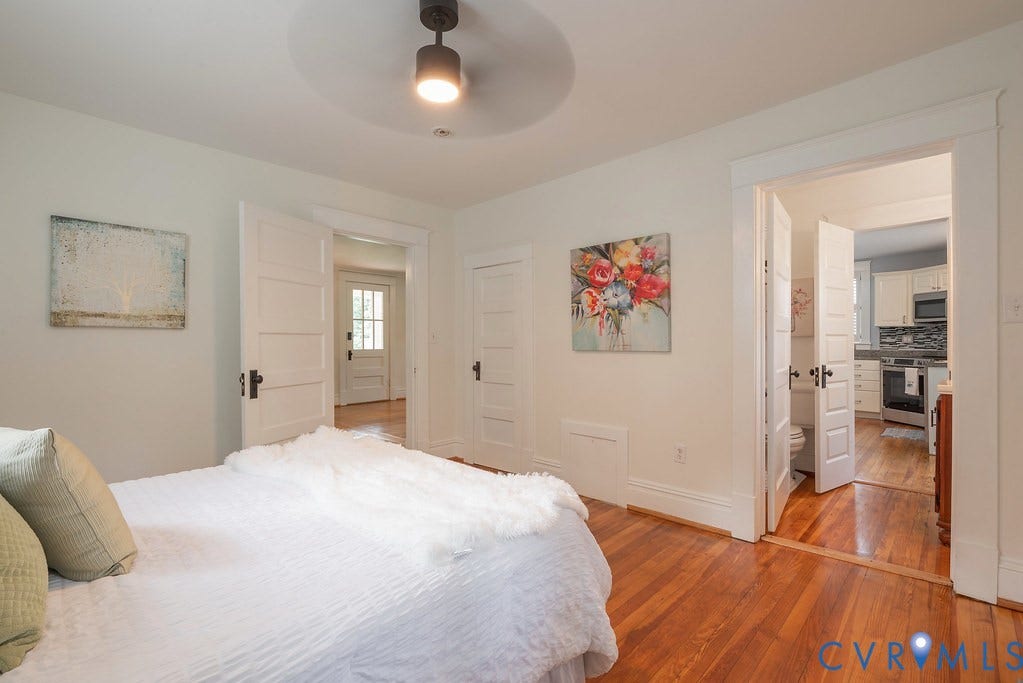 4808 River Road W Road, Goochland, VA 23063 Hardwood flooring extends throughout this space, featuring white walls, a ceiling fan with integrated lighting, and multiple paneled doorways