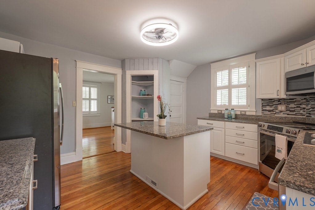 4808 River Road W Road, Goochland, VA 23063 Kitchen featuring wood-finish flooring, a central island, granite countertops, white cabinetry, and stainless steel appliances