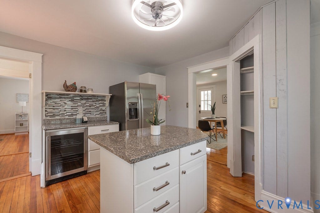 4808 River Road W Road, Goochland, VA 23063 Kitchen featuring a center island with granite countertop, stainless steel refrigerator, white cabinetry, wood-finish flooring, and a built-in wine cooler