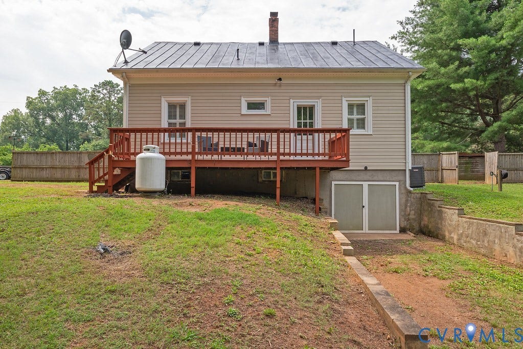 4808 River Road W Road, Goochland, VA 23063 Rear exterior featuring a wood deck with railings, vinyl siding, and a metal roof