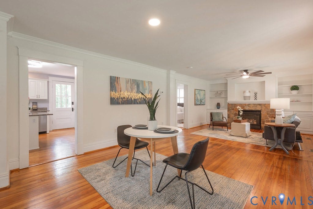 4808 River Road W Road, Goochland, VA 23063 Expansive living area featuring wood-finish flooring, a stone-faced fireplace with built-in shelving, crown molding, and recessed lighting