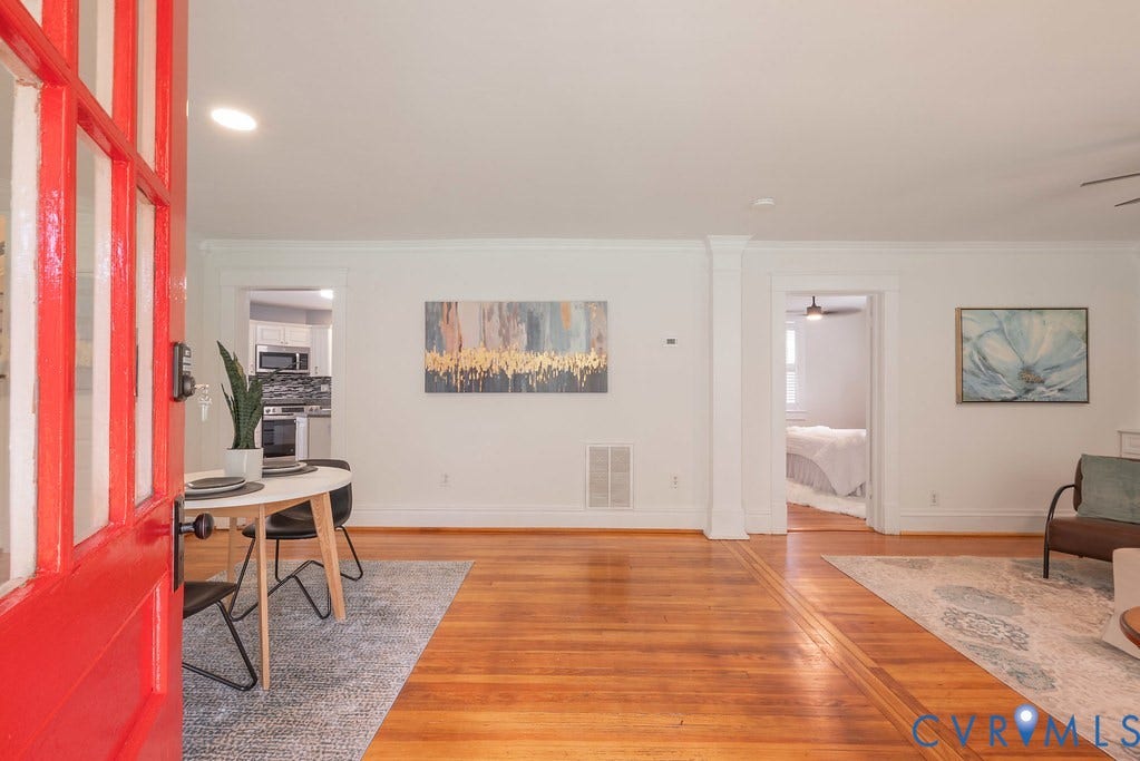 4808 River Road W Road, Goochland, VA 23063 Vibrant red entry door opens to interior featuring wood-finish flooring, white baseboards, and bright white walls