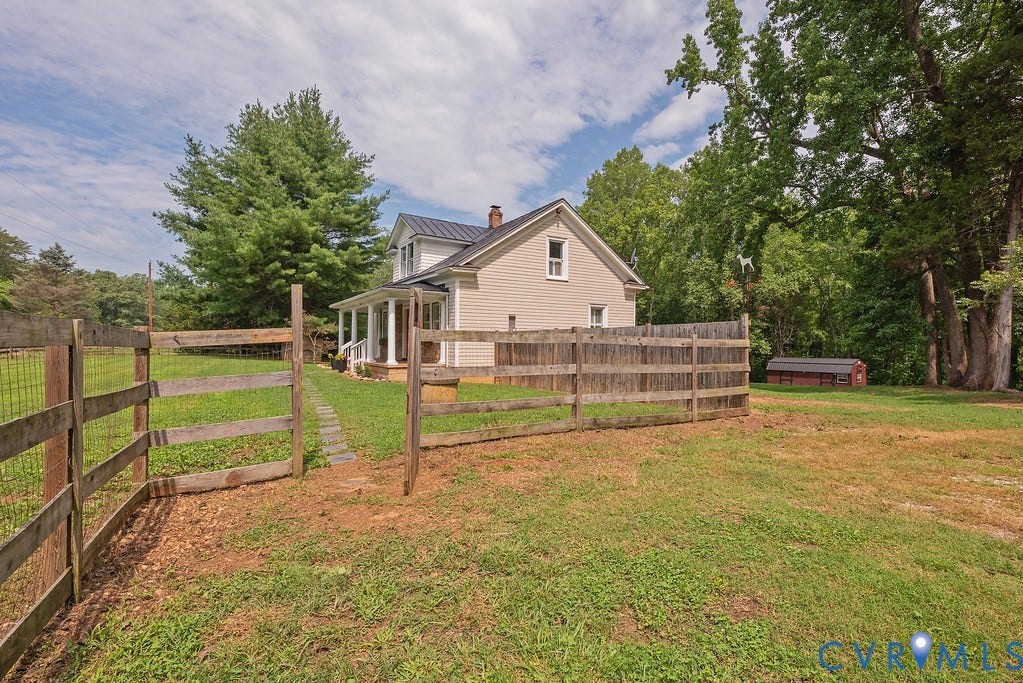 4808 River Road W Road, Goochland, VA 23063 Fenced yard area featuring a gravel path, mature trees, and a detached shed
