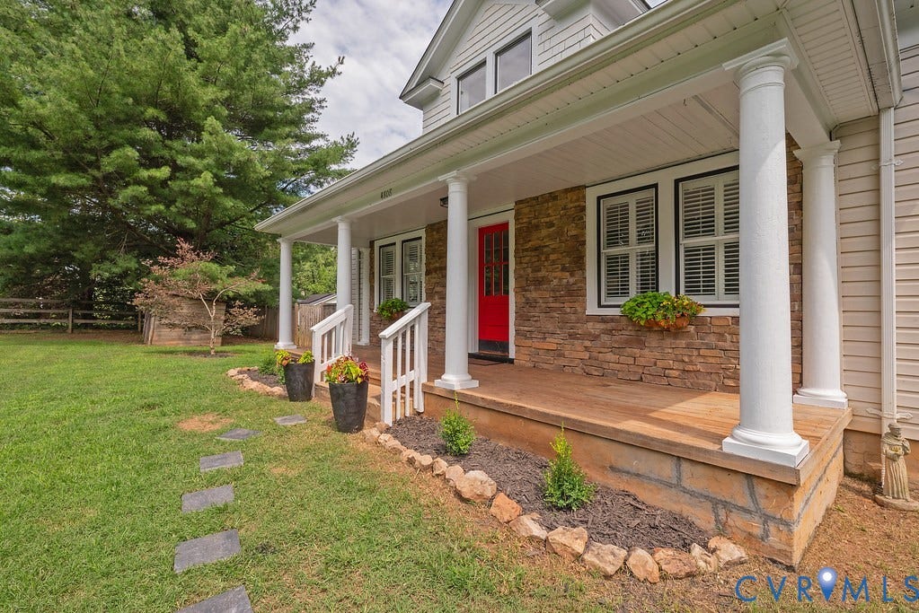 4808 River Road W Road, Goochland, VA 23063 Stone-faced residence featuring a prominent red entry door, a covered porch with white columns, and a wood-finish porch floor