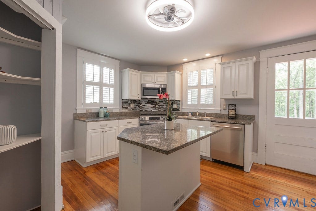 4808 River Road W Road, Goochland, VA 23063 Kitchen featuring white cabinetry, granite countertops, stainless steel appliances, and wood-finish flooring