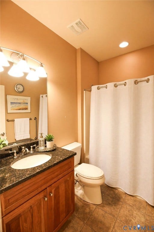 14007 Shawhan Court, Charter Colony, Midlothian, VA 23114 Wood-finish vanity with a drop-in sink, dark stone countertop, and tile flooring