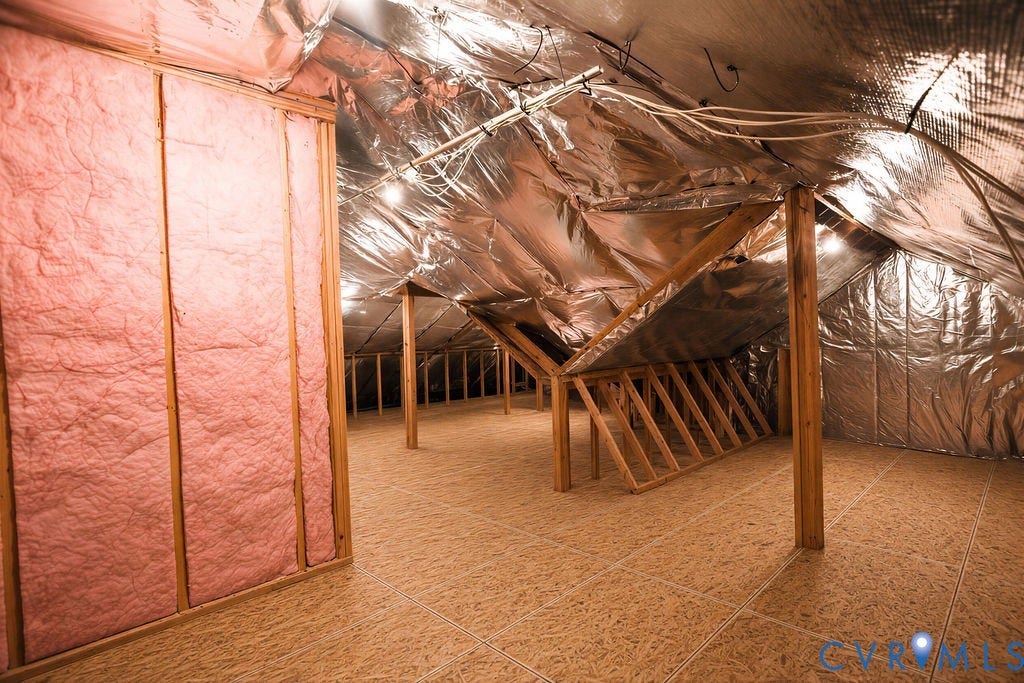 14007 Shawhan Court, Charter Colony, Midlothian, VA 23114 Foil-backed insulation, exposed wood framing, and a tiled floor surface define this functional attic space