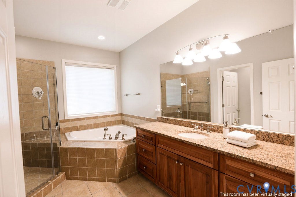 14007 Shawhan Court, Charter Colony, Midlothian, VA 23114 Tiled corner soaking tub, glass-enclosed shower, dual sink vanity with granite countertop, and wood-finish cabinetry