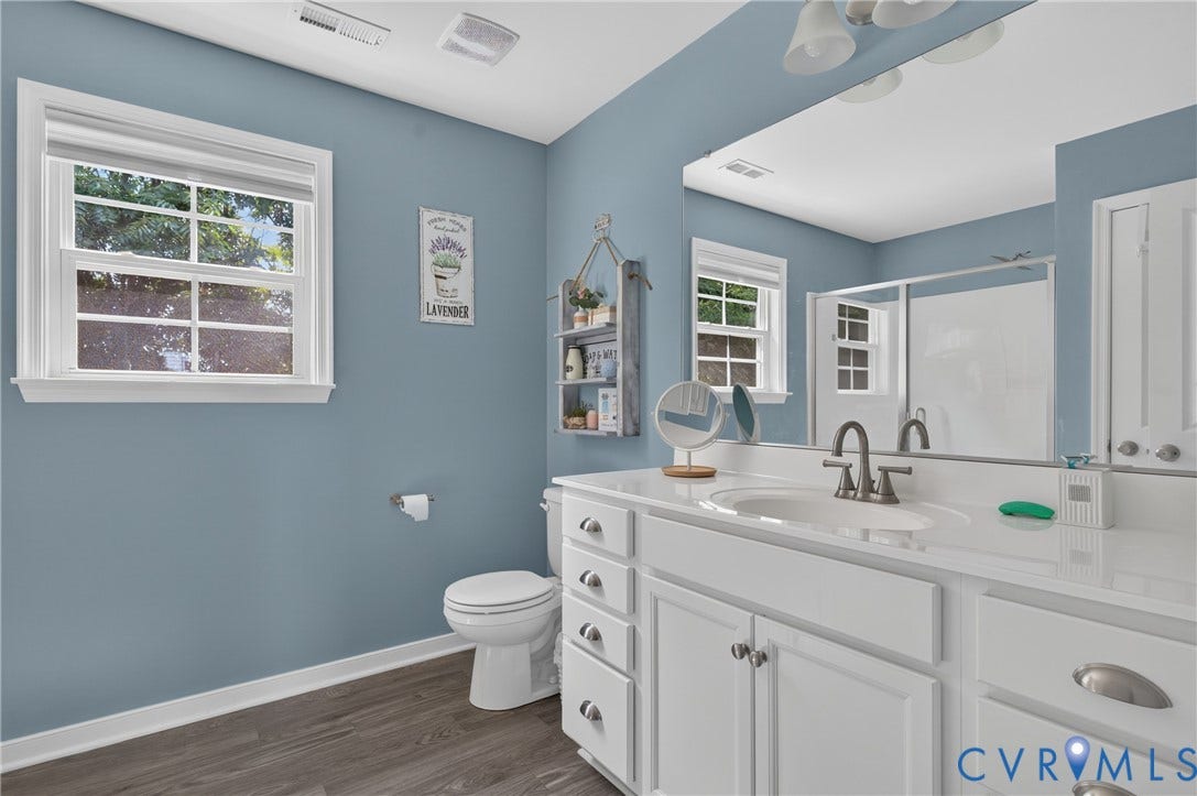 311 Cardinal Road, Countryside, Louisa, VA 23093 Bathroom featuring a white vanity with an integrated sink, brushed nickel faucet, and a large mirror