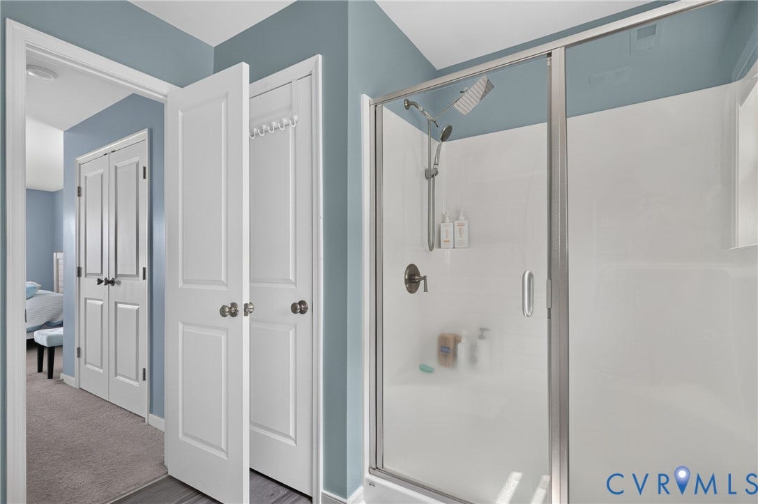 311 Cardinal Road, Countryside, Louisa, VA 23093 Glass-enclosed shower with a multi-function showerhead and brushed nickel fixtures