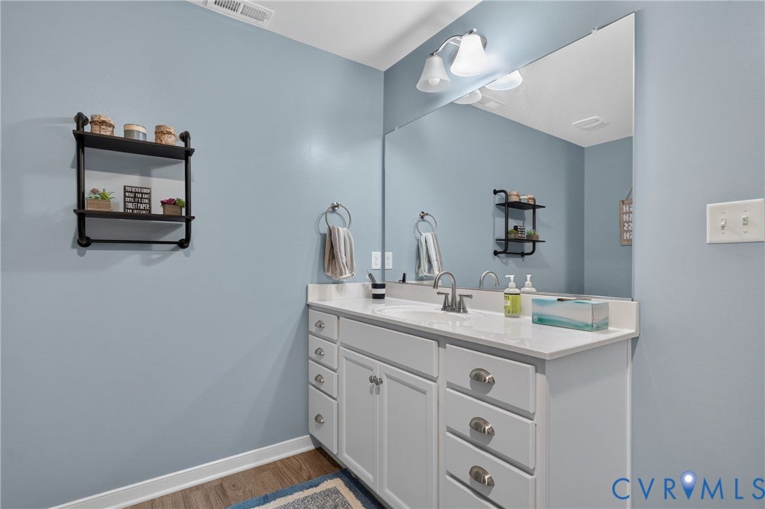 311 Cardinal Road, Countryside, Louisa, VA 23093 Double vanity with white cabinetry and chrome hardware, featuring a white countertop and dual undermount sinks