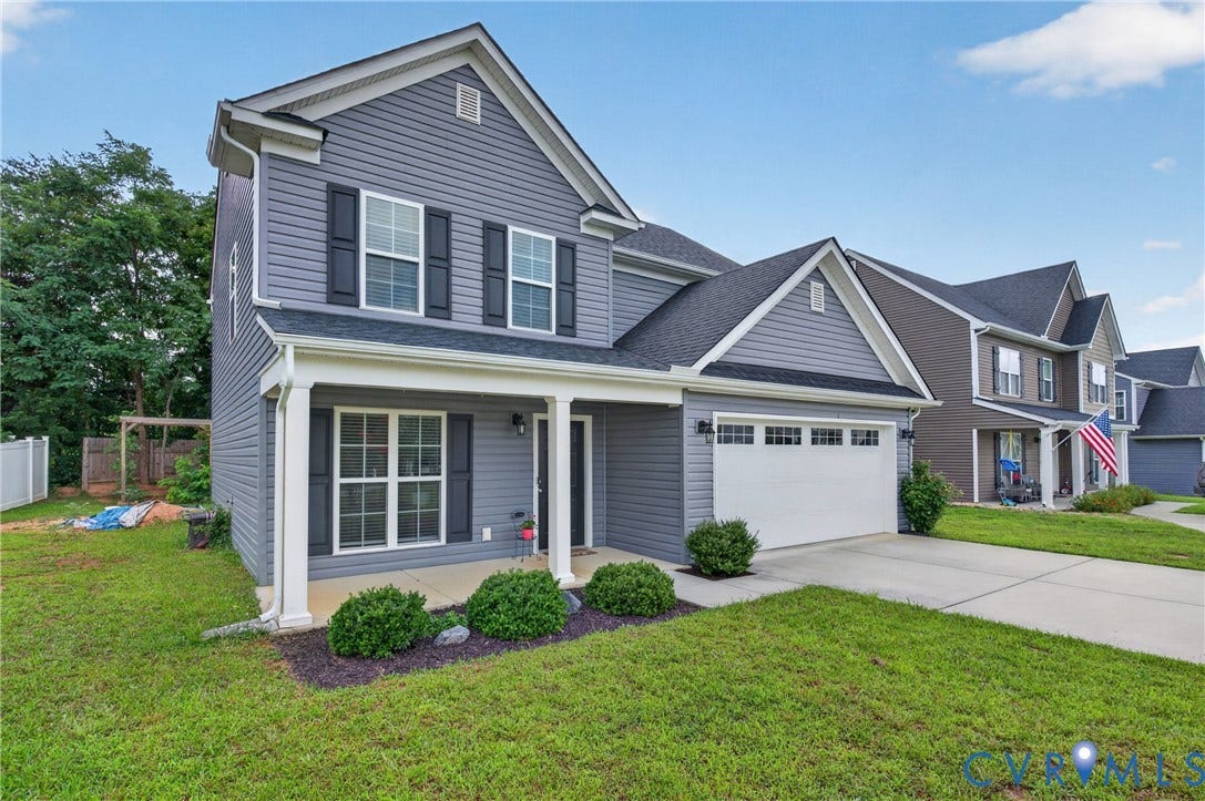 311 Cardinal Road, Countryside, Louisa, VA 23093 Two-story home with a two-car garage, gray siding, and a covered front porch with white columns