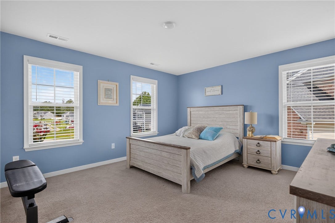 311 Cardinal Road, Countryside, Louisa, VA 23093 Bedroom featuring light blue walls, two windows with white blinds, and neutral carpet flooring