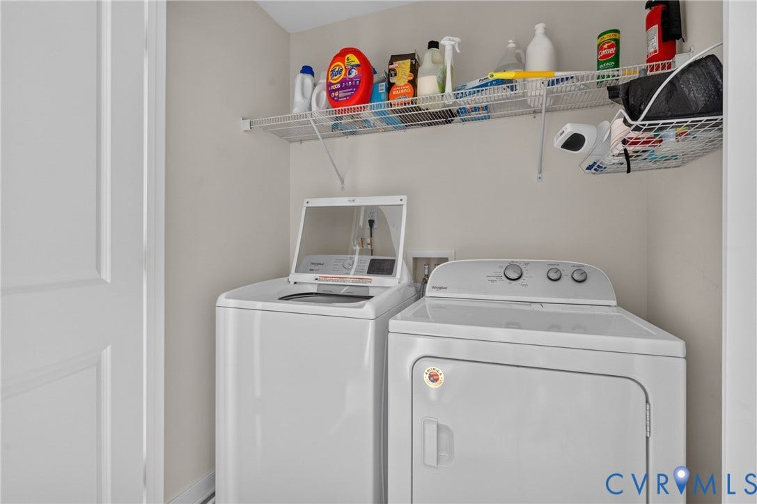 311 Cardinal Road, Countryside, Louisa, VA 23093 Dedicated laundry area featuring a white top-load washer and dryer set, wire shelving, and neutral wall tones